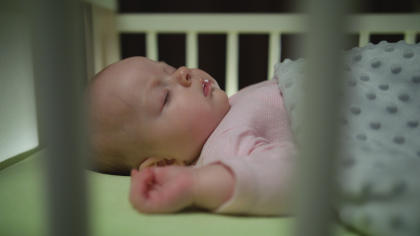 Sleeping newborn baby in crib