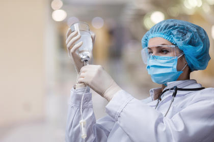 Doctor preparing IVIG bottle for infusion