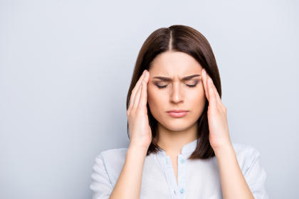 Woman with headache as a side effect of taking Abrilada