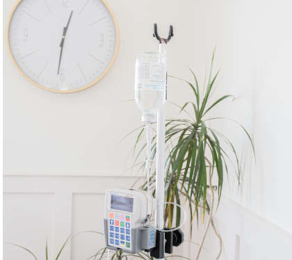 Setup for home infusion, with IV stand, bottle and pump