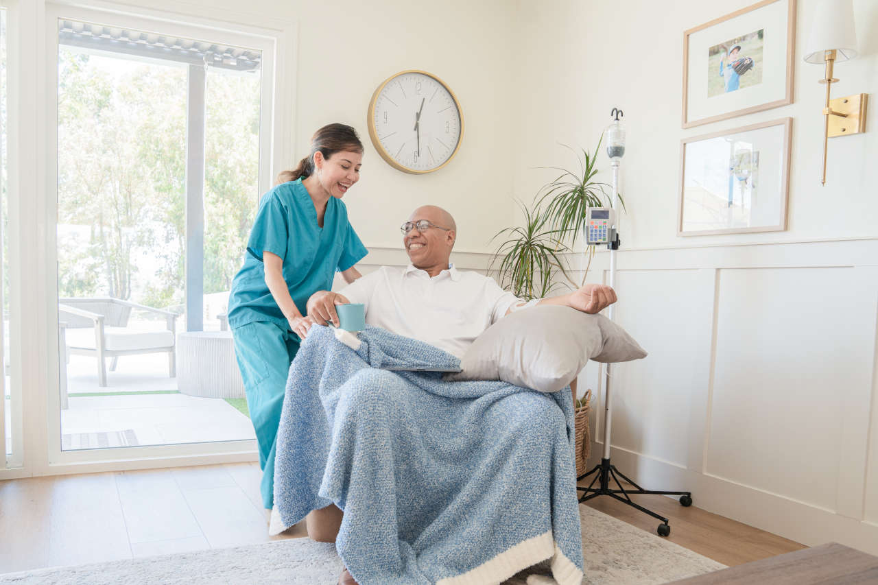 Nurse with patient receiving home infusion therapy