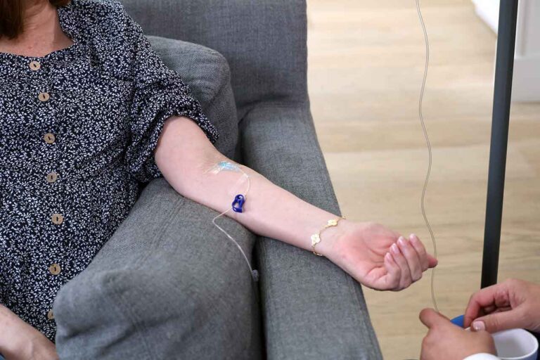 Closeup of the arm of a woman receiving IVIG therapy