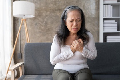 A woman holding her chest in pain