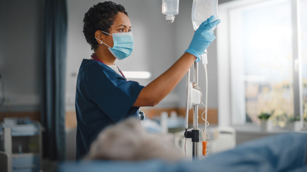 A nurse monitoring IV bags