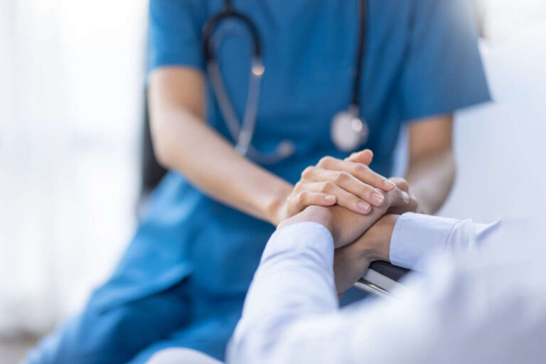 A healthcare provider comforting a patient