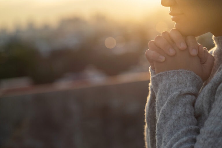 A woman with clasped hands