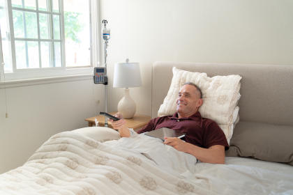 Man in bed receiving Ig therapy