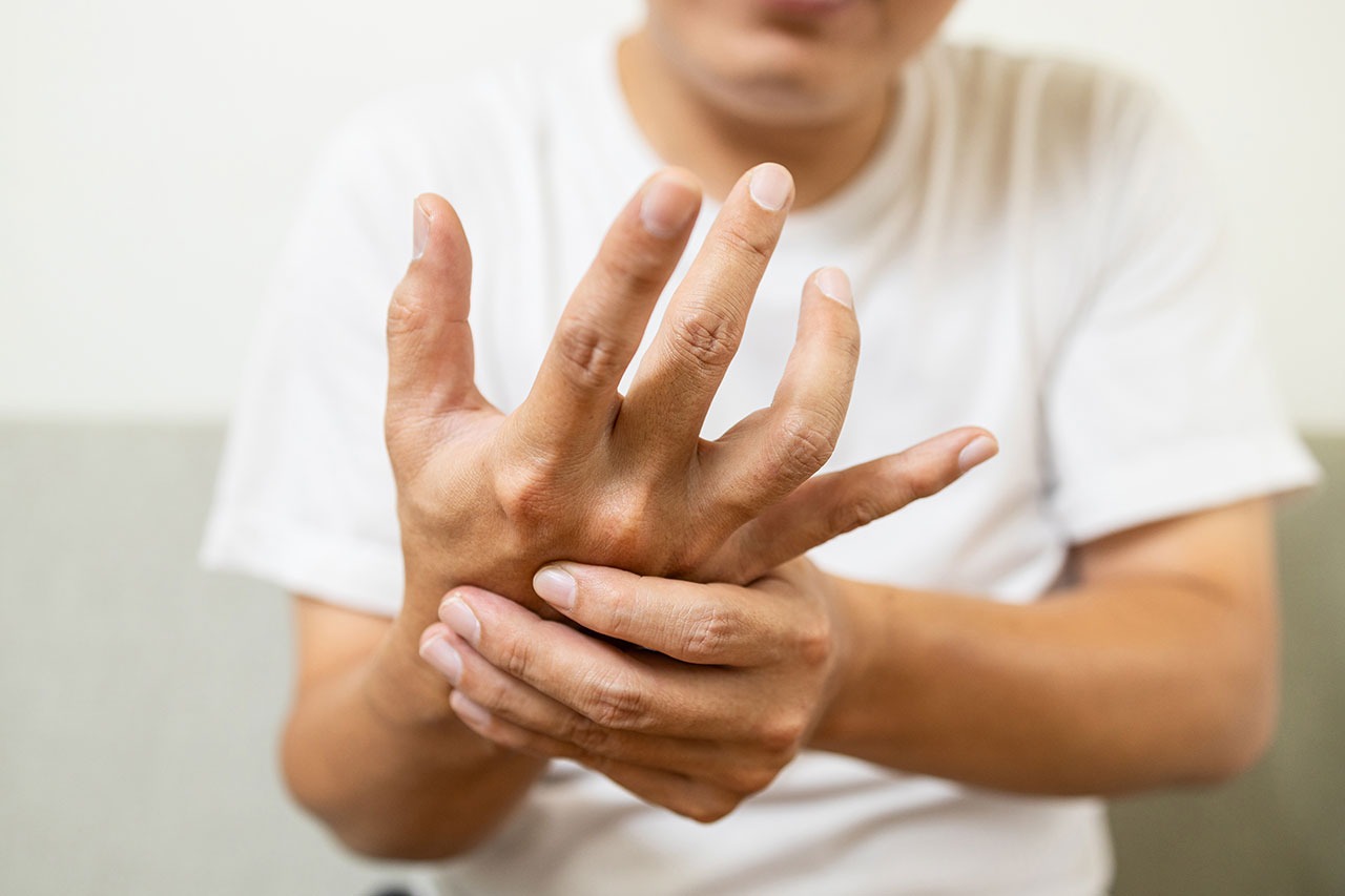 A man holding his hand in pain