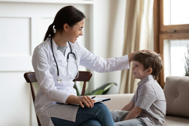 Female doctor consulting with boy about Idelvion