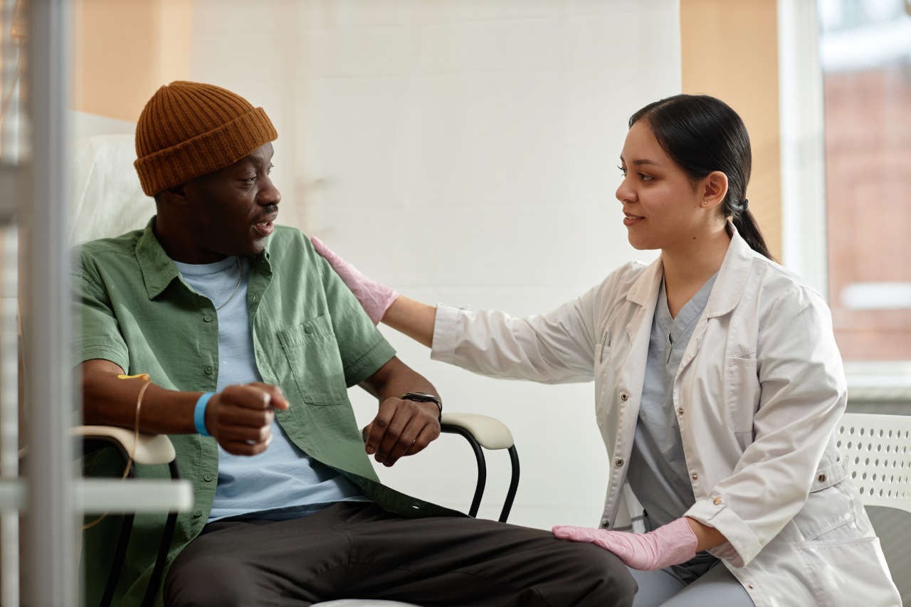 A nurse comforting a patient receiving infusion therapy