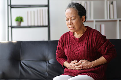 Woman experiencing nausea after IVIG therapy