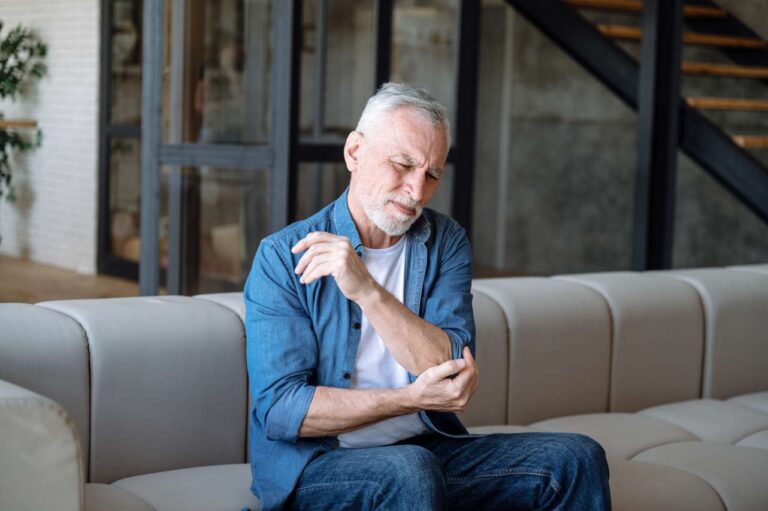 A man holding his elbow in pain