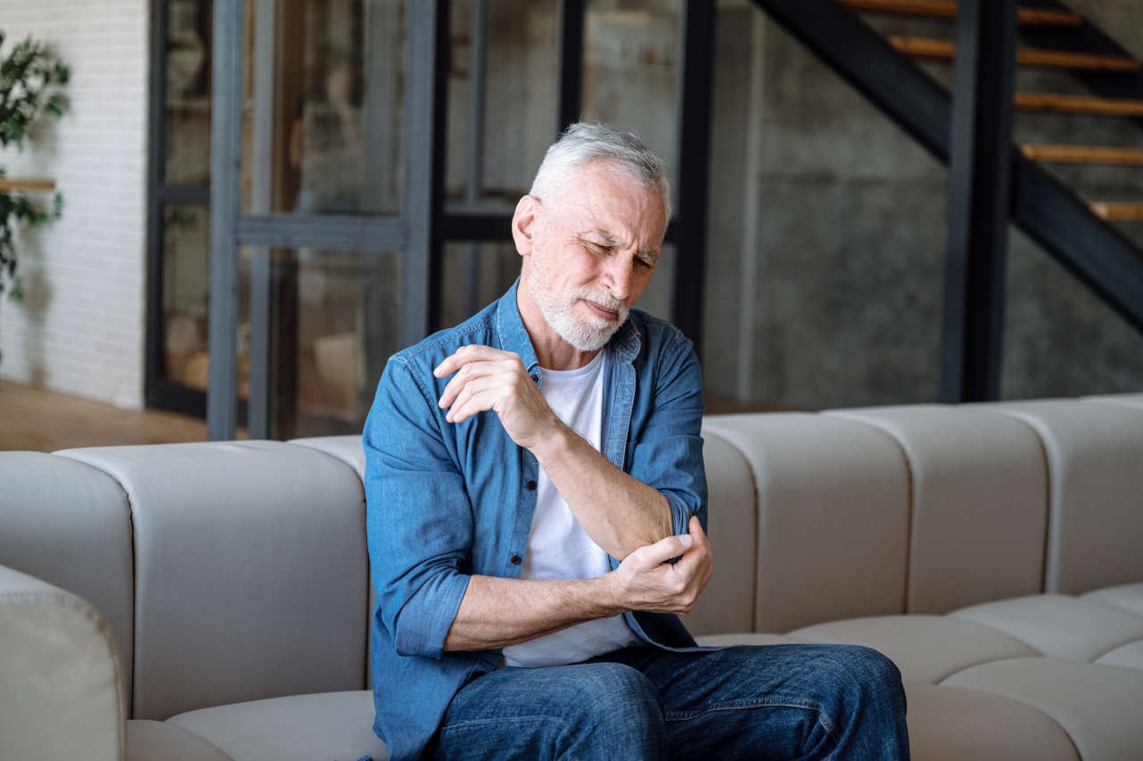 A man holding his elbow in pain