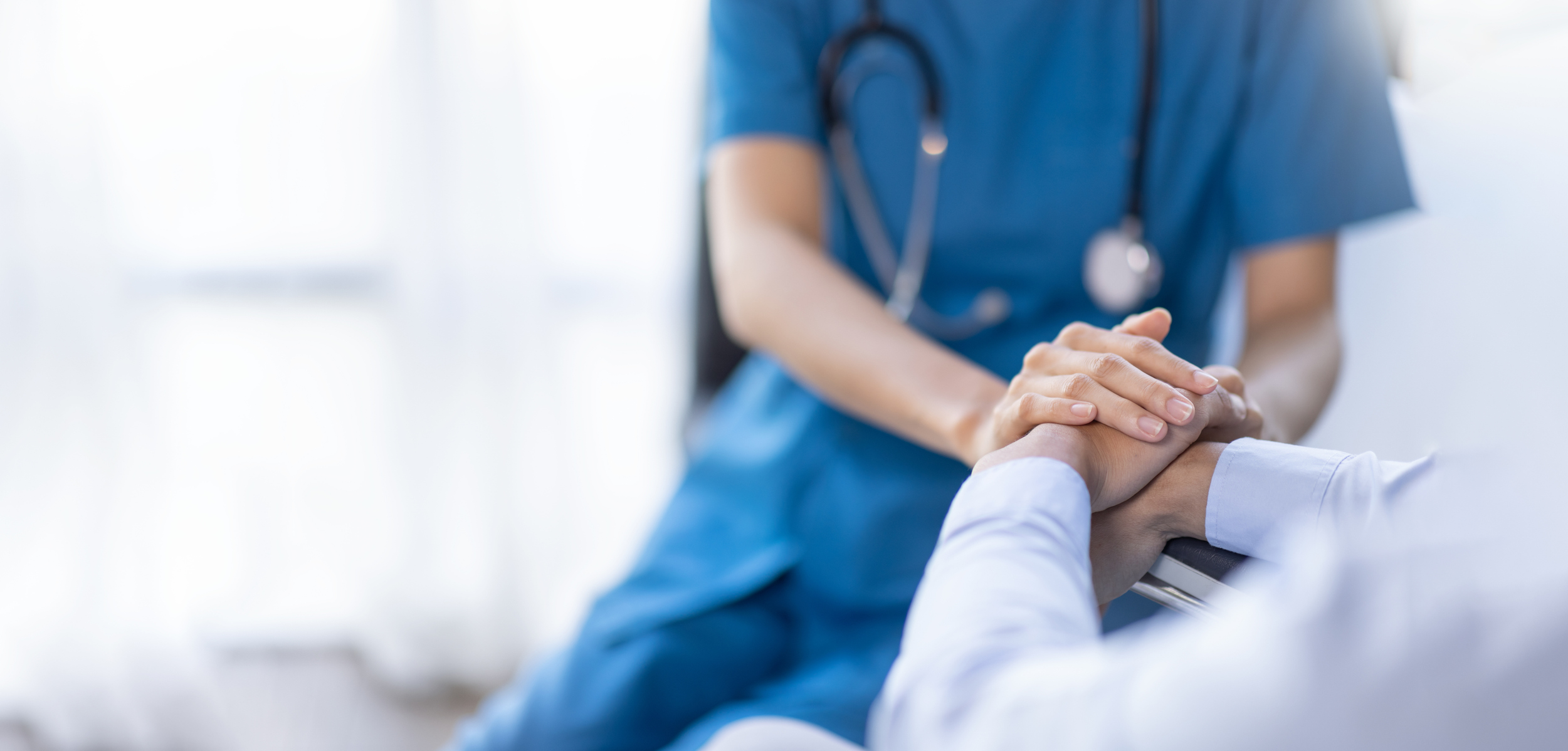 A healthcare provider comforting a patient