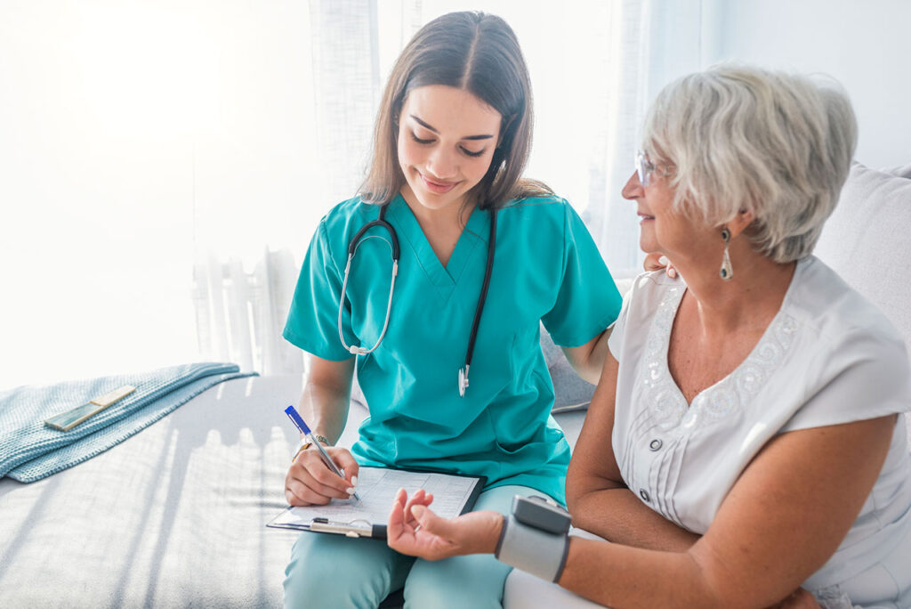 A nurse checking a woman’s blood pressure