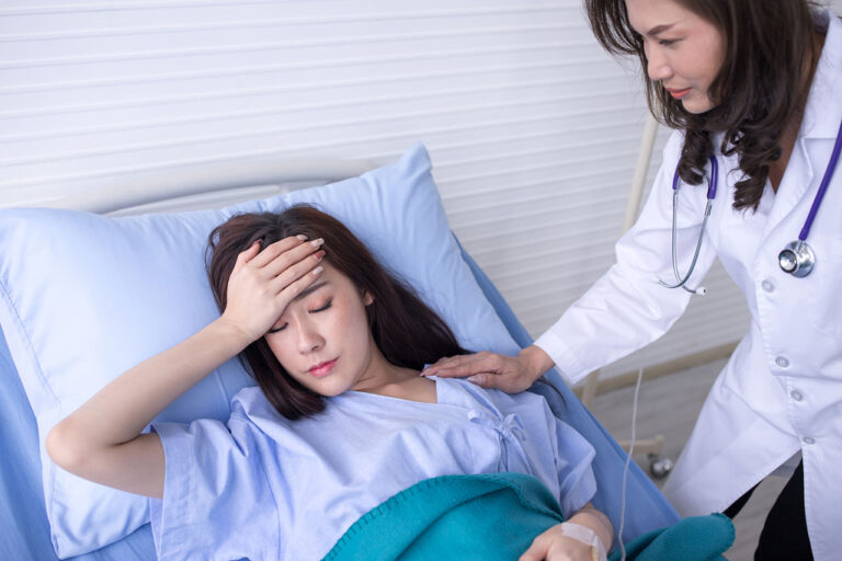 A doctor checking on a patient with post-transfusion purpura