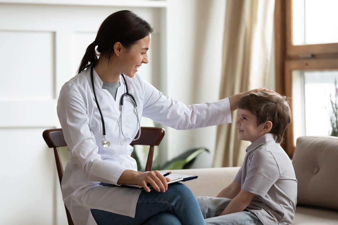 A doctor stroking the head of a young patient