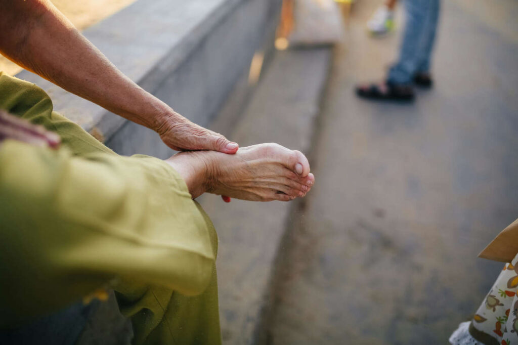 A person holding his tingling foot