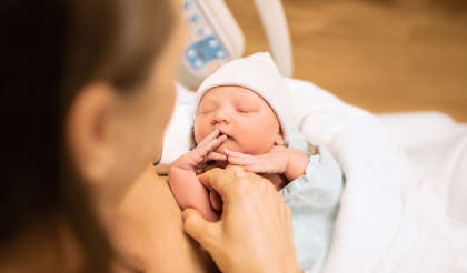 A mother holding her newborn baby