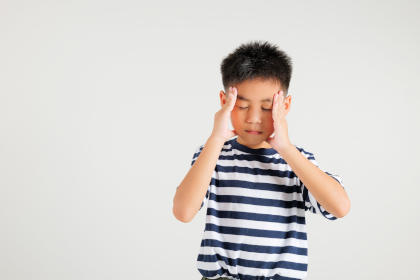 Boy suffering from a headache as a side effect of Alprolix