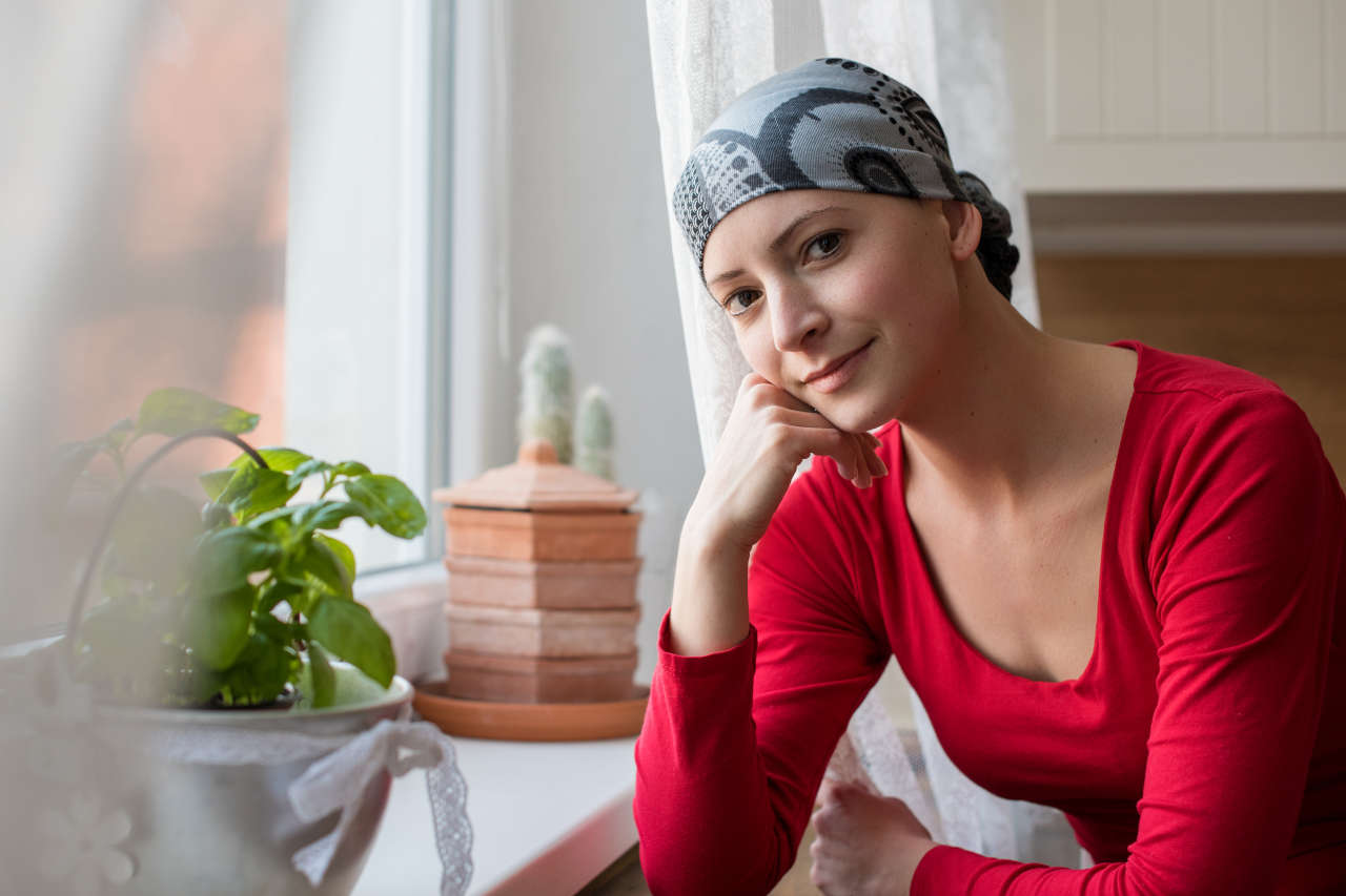Chemotherapy patient on Fylnetra sitting next to a window