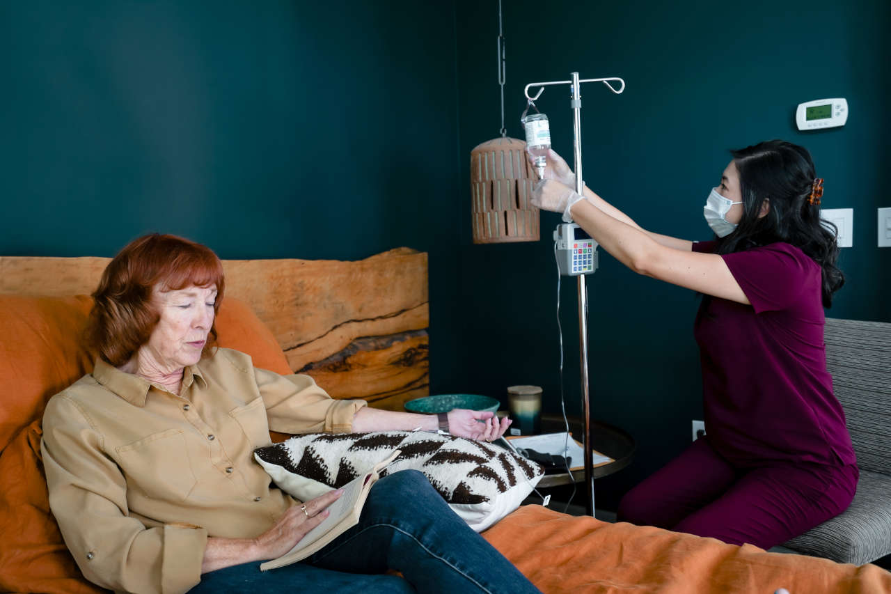 Nurse with patient receiving IVIG in Hyperimmunoglobulinemia E Syndrome (HIES)