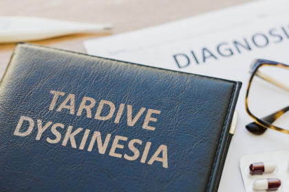 A tardive dyskinesia book on a doctor's desk