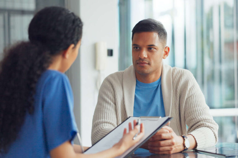 Patient in an office discussing Altuviiio with a healthcare professional