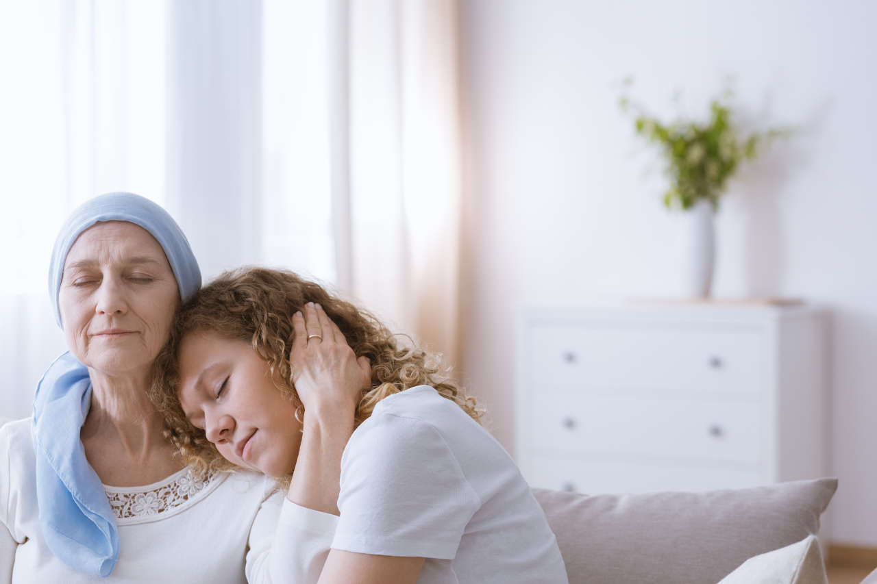 Cancer patient experiencing stress and being comforted by daughter