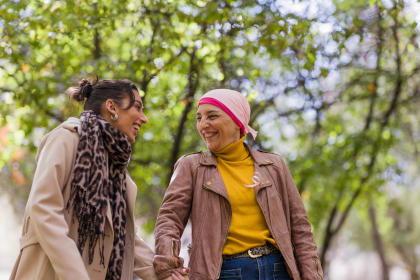 Cancer patient walking in a park with a friend