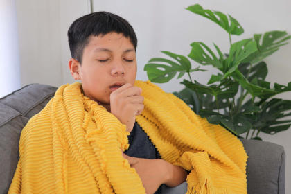 Boy experiencing cough, a side effect of Jivi