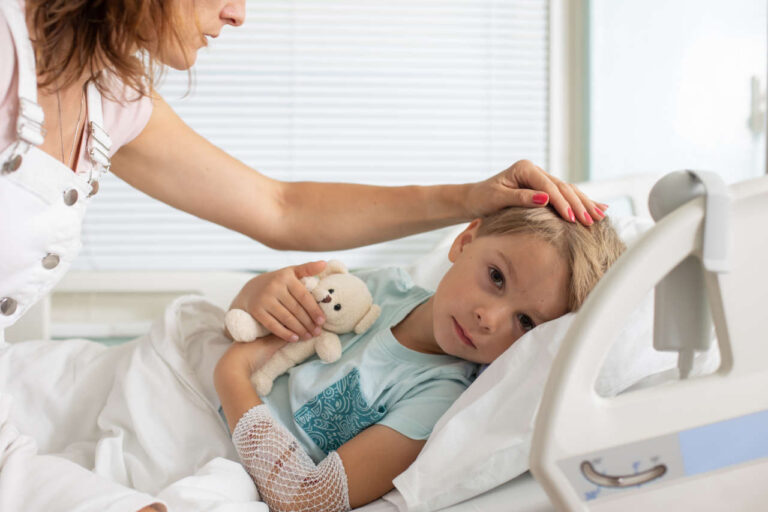 Child showing symptoms of hemophilia on a hospital bed