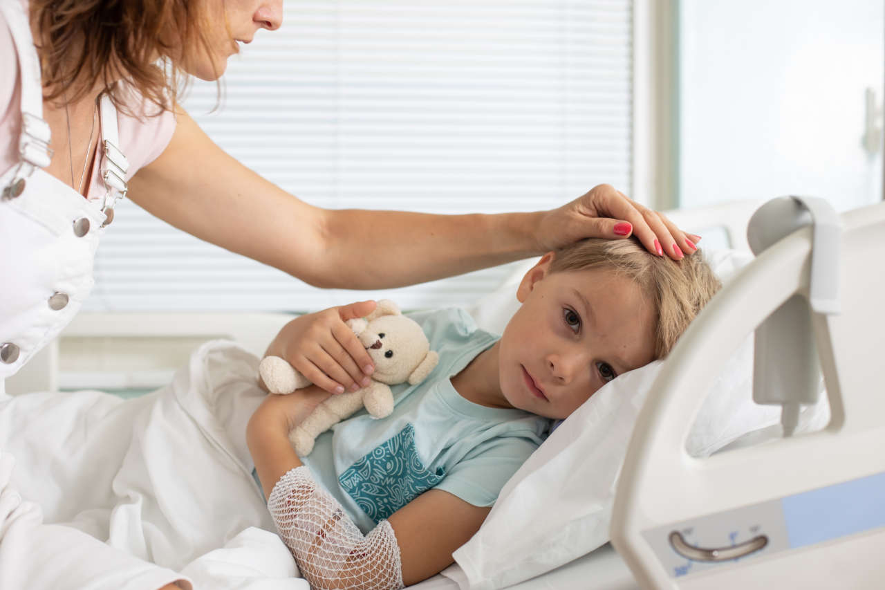 Child showing symptoms of hemophilia on a hospital bed