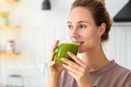 Cancer patient worried about weight loss drinking a green smoothie