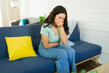 Woman experiencing nausea as a side effect of taking Vonvendi