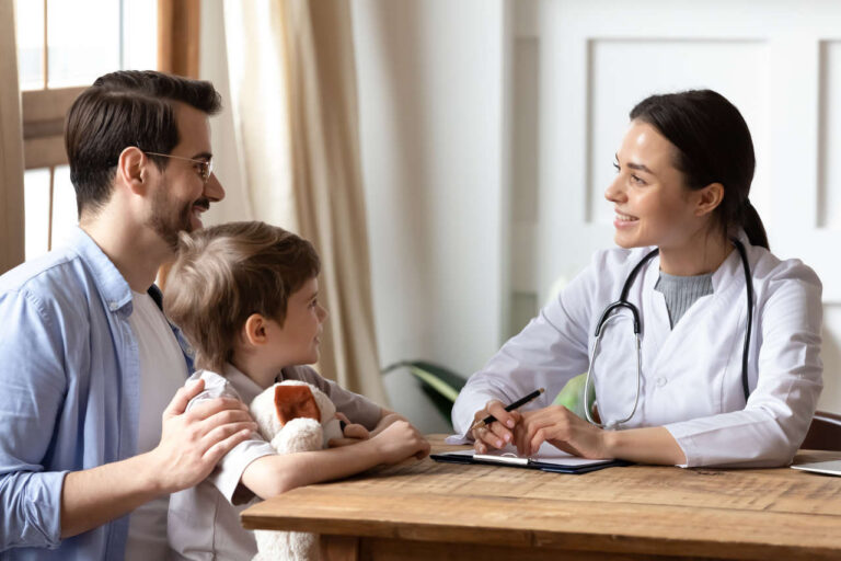 Doctor talking to a boy and his father about Kovaltry