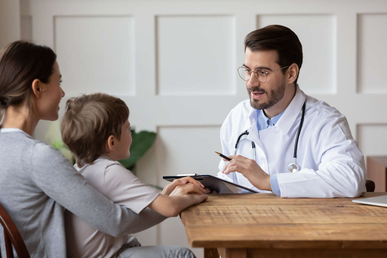 Doctor talking to a boy and her mother about Xyntha