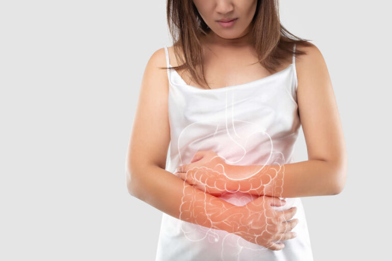 Woman with short bowel syndrome clenching stomach