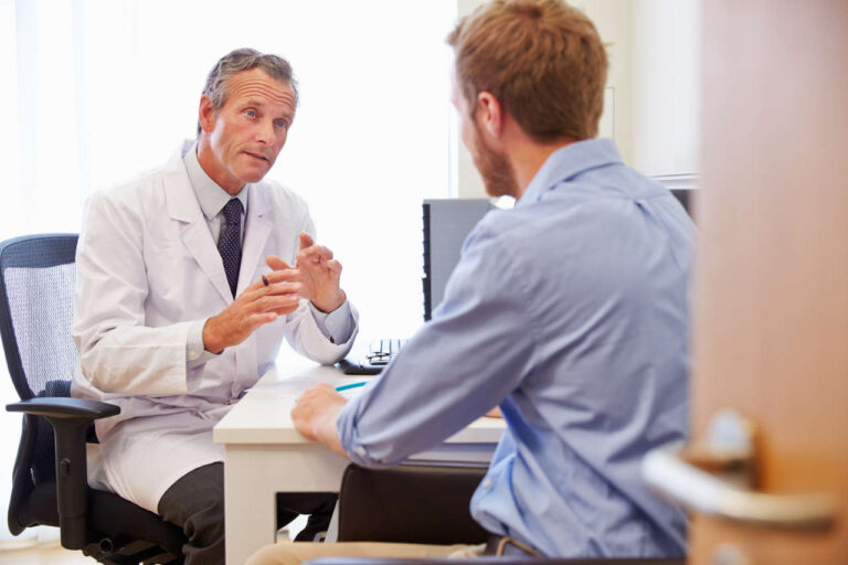 Doctor in an office discussing Alphanate SD with a male patient
