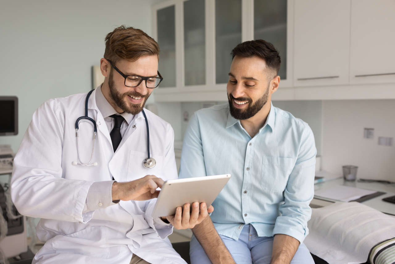 Doctor with tablet discussing Benefix with a patient in a hospital