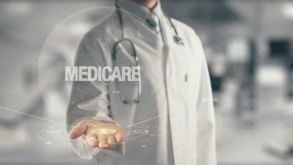 Medical concept image of Medicare, featuring a doctor in futuristic medical setting